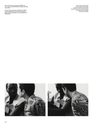 Black and white fashion editorial featuring two men in patterned shirts having a discussion indoors under natural lighting.