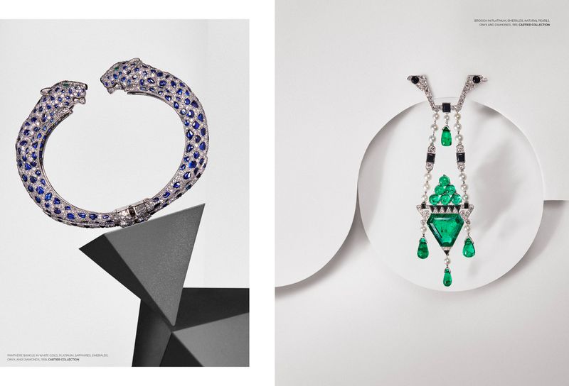 Elegant jewelry flat lay featuring a panther bangle on a gray geometric base and a gem-encrusted pendant against a white backdrop.