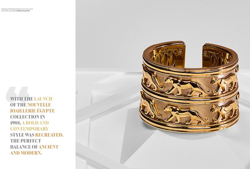 Elegant gold bangle featuring a pattern of stylized leopards displayed on a white surface; luxury jewelry fashion editorial.