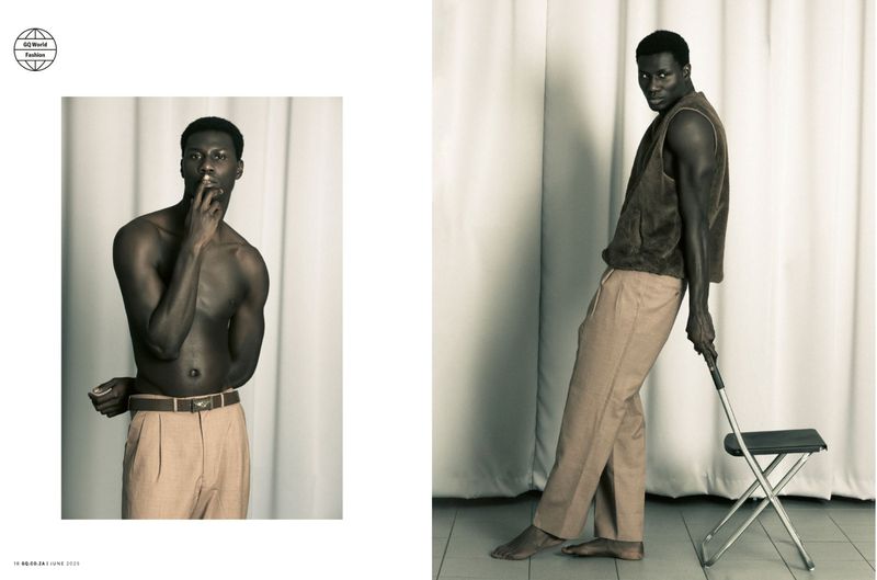 A dark-skinned man poses in a sepia-toned fashion editorial wearing trousers; another man wears a vest and leans against a metal chair.