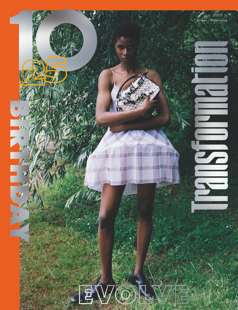 A young woman with dark skin stands in a dress holding a purse on a magazine cover with text and a natural green background.