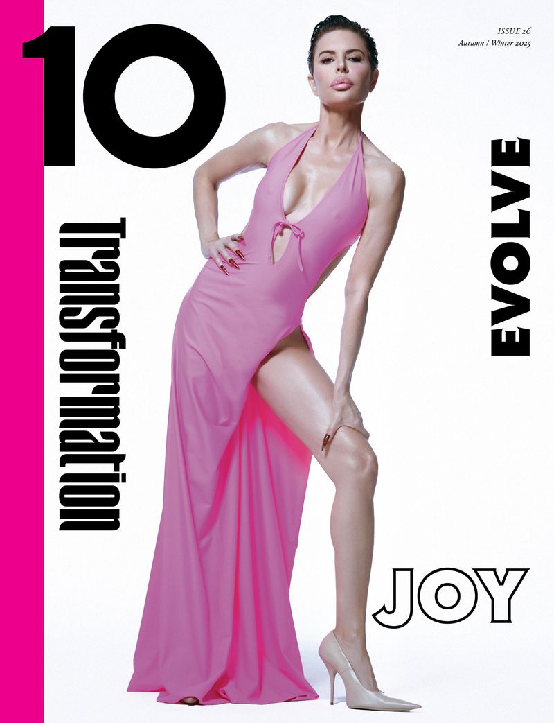 Fashion magazine cover featuring a female model in a pink dress and heels, posing in a studio setting against a white background.