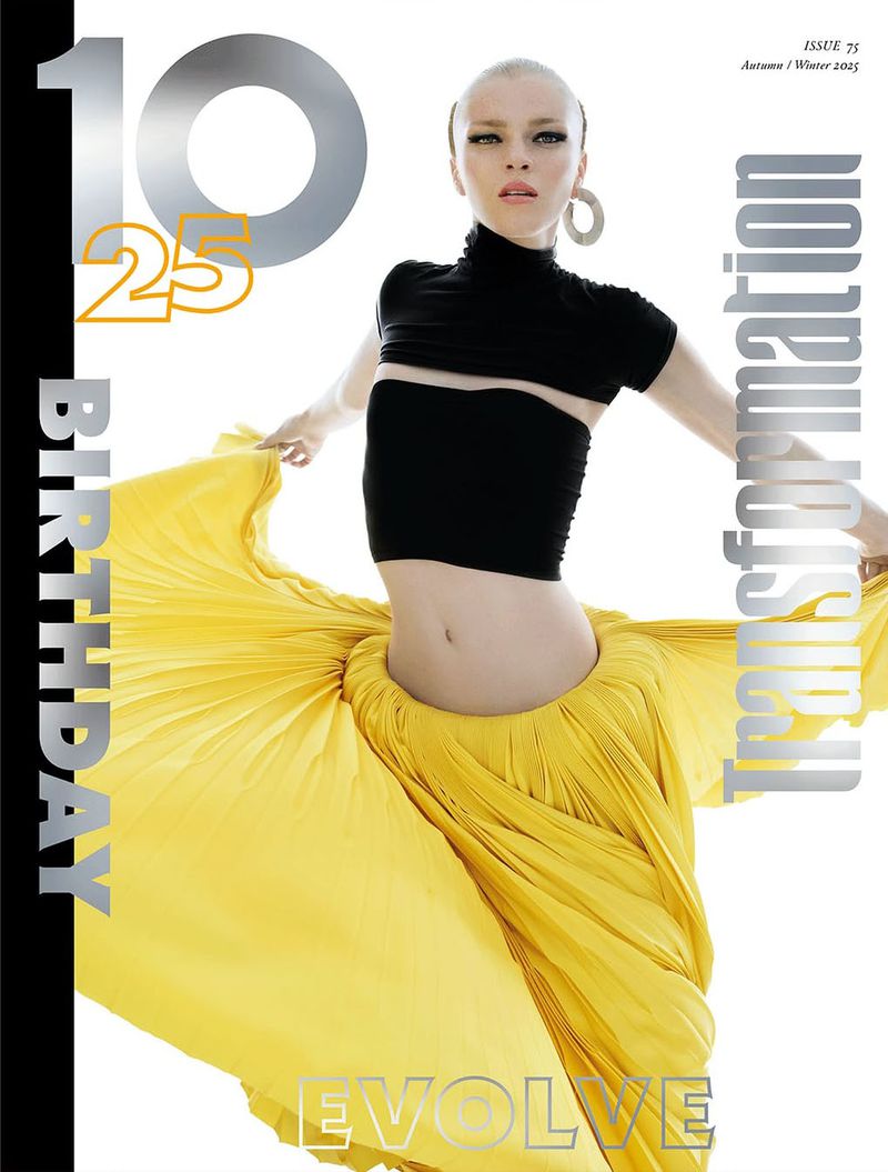 Magazine cover featuring a posed female model wearing a black top and flowing yellow skirt, with large typography and a white backdrop.