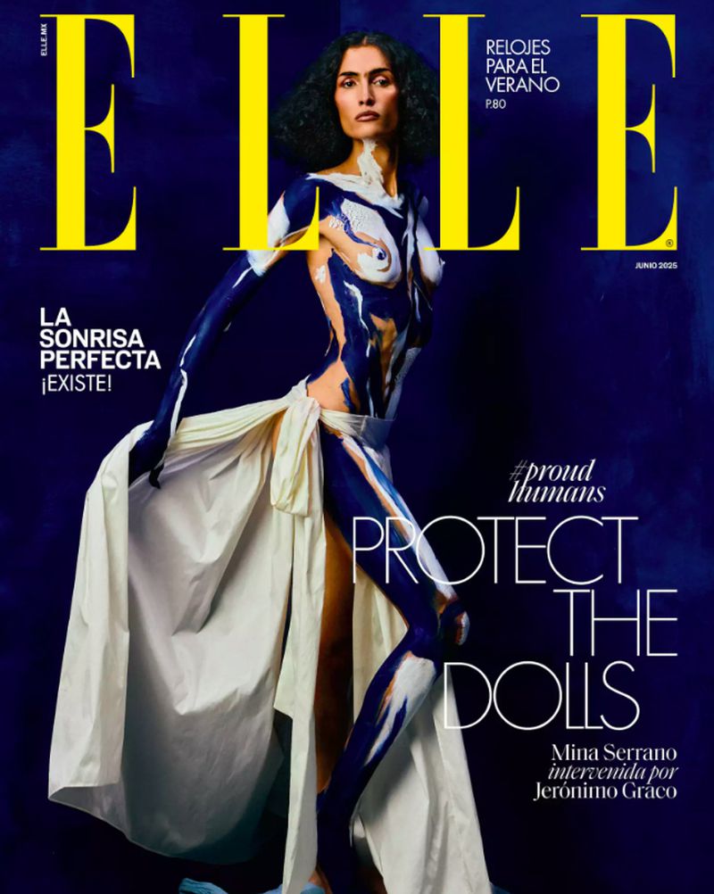 Elle Magazine cover featuring a fashion model with body paint wearing a long, white skirt, posing against a dark blue background.