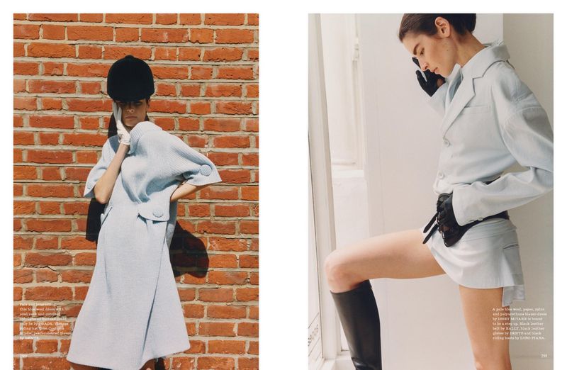 Fashion editorial shot: A model in a light blue outfit and riding helmet poses against a brick wall and in a white room.