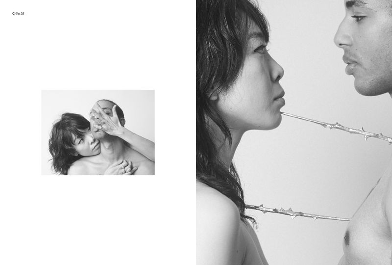 Black and white studio portrait of an Asian woman and African American man connected by a decorative thorny vine, close up, expressive.