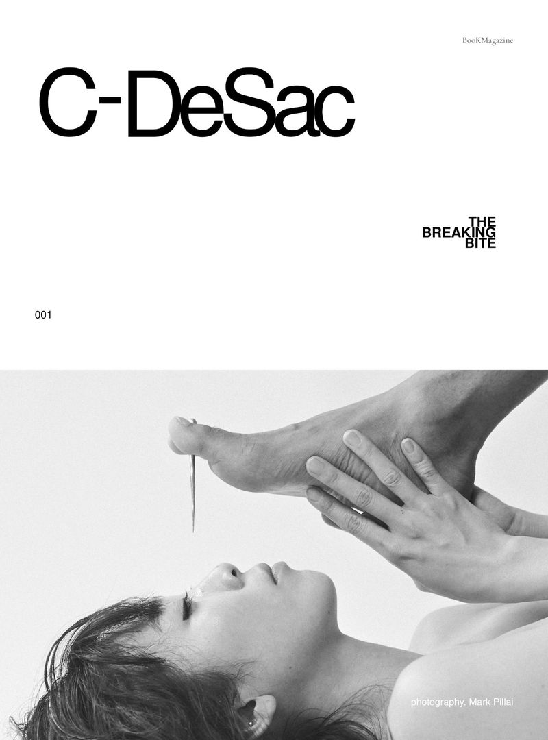 Magazine cover with a woman lying down as someone holds a foot above her face with a needle piercing the big toe in a studio.