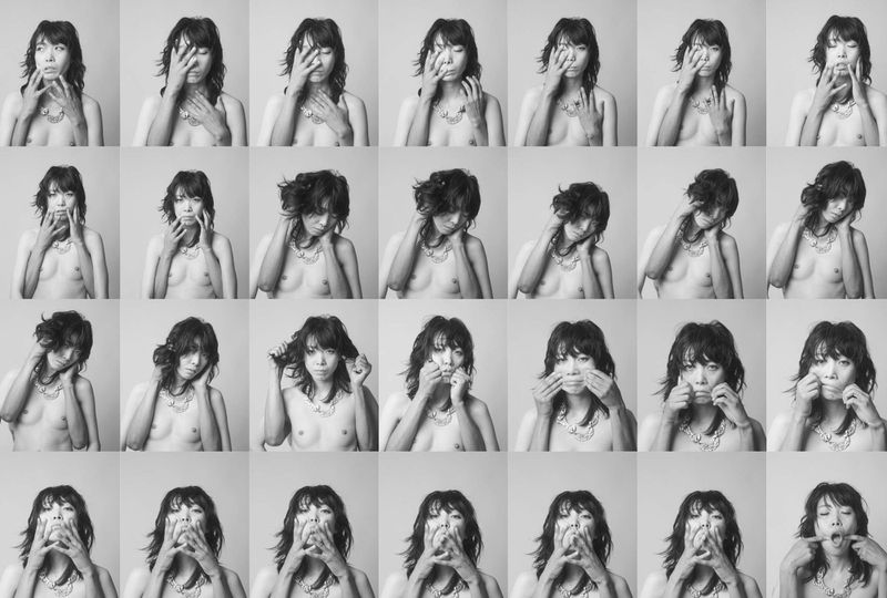 A monochrome grid featuring a woman with dark hair and a necklace making various expressions and gestures with her hands toward her face.
