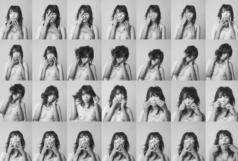 A monochrome grid featuring a woman with dark hair and a necklace making various expressions and gestures with her hands toward her face.