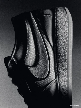 Monochromatic close-up shot of a black and gray Nike Blazer sneaker featuring the iconic Swoosh logo and textured rubber sole.