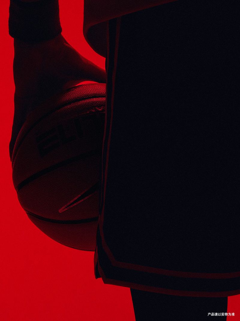 Close-up of a basketball player holding a basketball against a striking red background for Nike SU25 CHBL campaign.