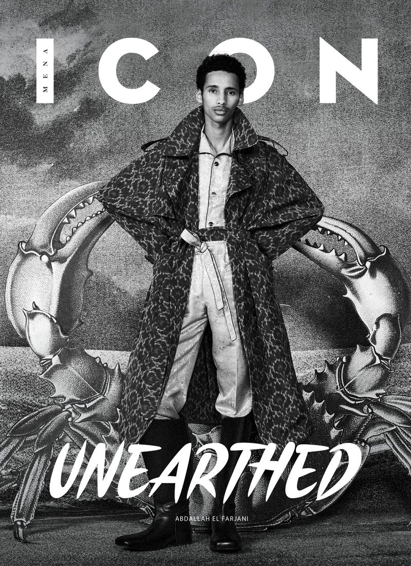 Fashion magazine cover featuring a male model in an overcoat, posing against a crab claw graphic with the title 'ICON' in white letters.