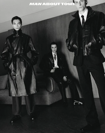 Three men in black leather jackets and suits pose indoors, showcasing modern, edgy fashion in a monochrome editorial style.