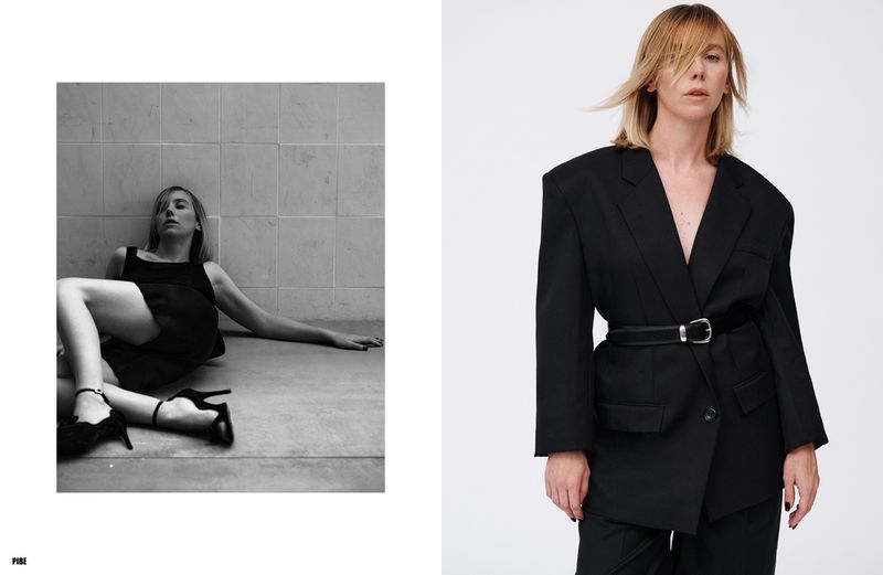 Fashion spread with a woman in a black blazer and heels leaning against a tiled wall, captured in a high-contrast black and white studio shot.