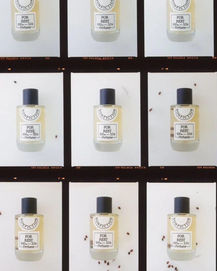 Film contact sheet grid featuring Nonfiction For Rest perfume bottles with black caps and scattered seeds on a white background.