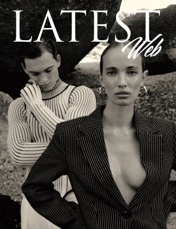 Editorial fashion shot: two models, one in striped blazer and earrings, the other in a striped turtleneck, posed against a rock background.
