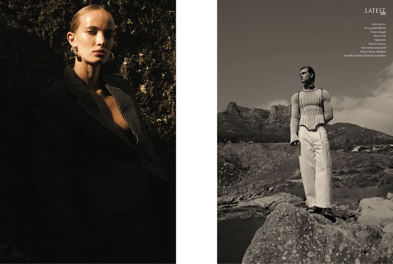 Monochrome fashion editorial featuring a blonde woman in a dark coat near rocks and a man in a light-colored outfit with a mountain backdrop.