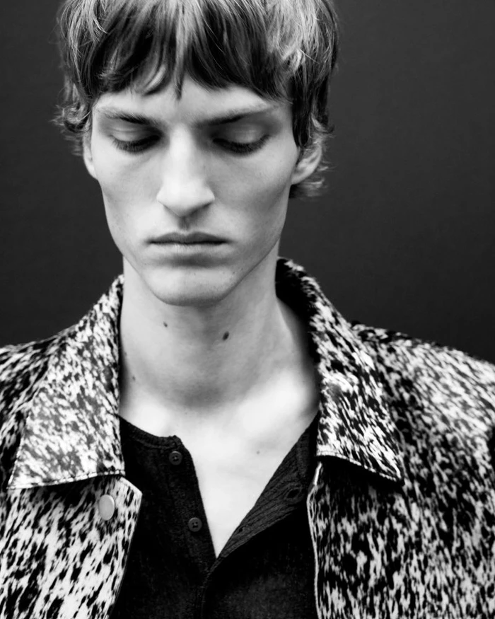 Close-up portrait of a male model wearing a patterned textured jacket for Zara Leather Capsule