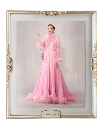 Woman in a pink feathered gown posing inside an ornate silver frame against a light background. Fashion shot, studio lighting.