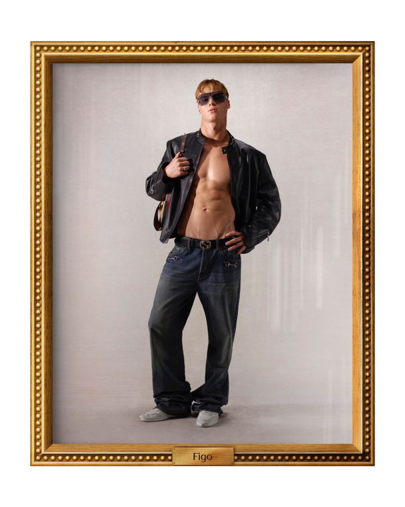 Muscular man in jeans and a leather jacket strikes a confident pose in a studio portrait against a neutral backdrop, framed in gold.