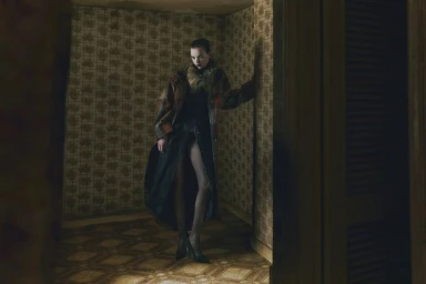 Model wearing a patterned coat with fur collar standing in a vintage room with patterned wallpaper.