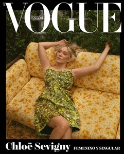 Chloë Sevigny wearing a green patterned dress reclining on a vintage yellow floral sofa outdoors for Vogue España.