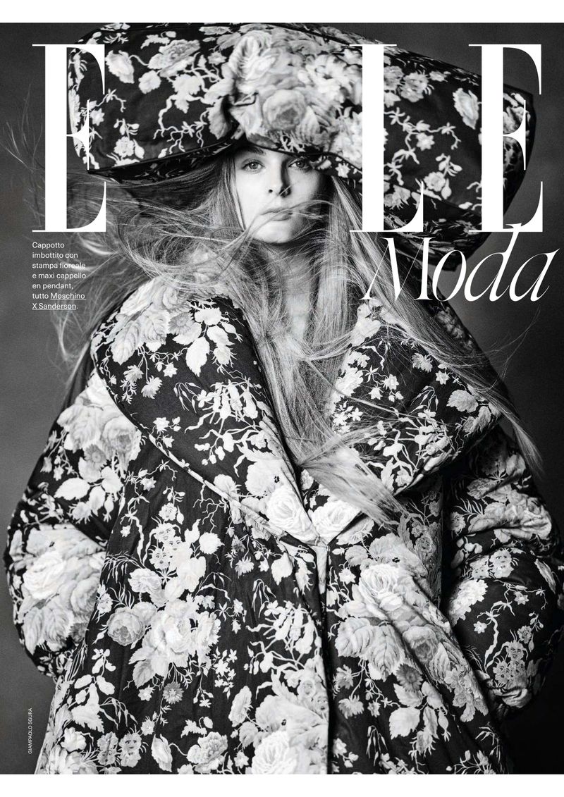 Black and white fashion magazine cover featuring a model in a floral coat and hat, with bold magazine typography.