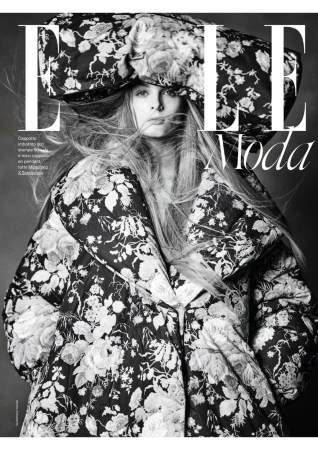 Black and white fashion magazine cover featuring a model in a floral coat and hat, with bold magazine typography.