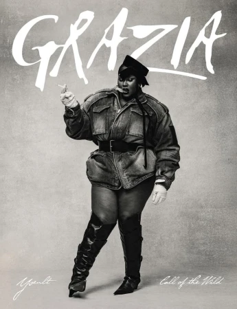 Plus-size woman in denim jacket and thigh-high boots posing against a gray backdrop with 'Grazia' magazine logo.