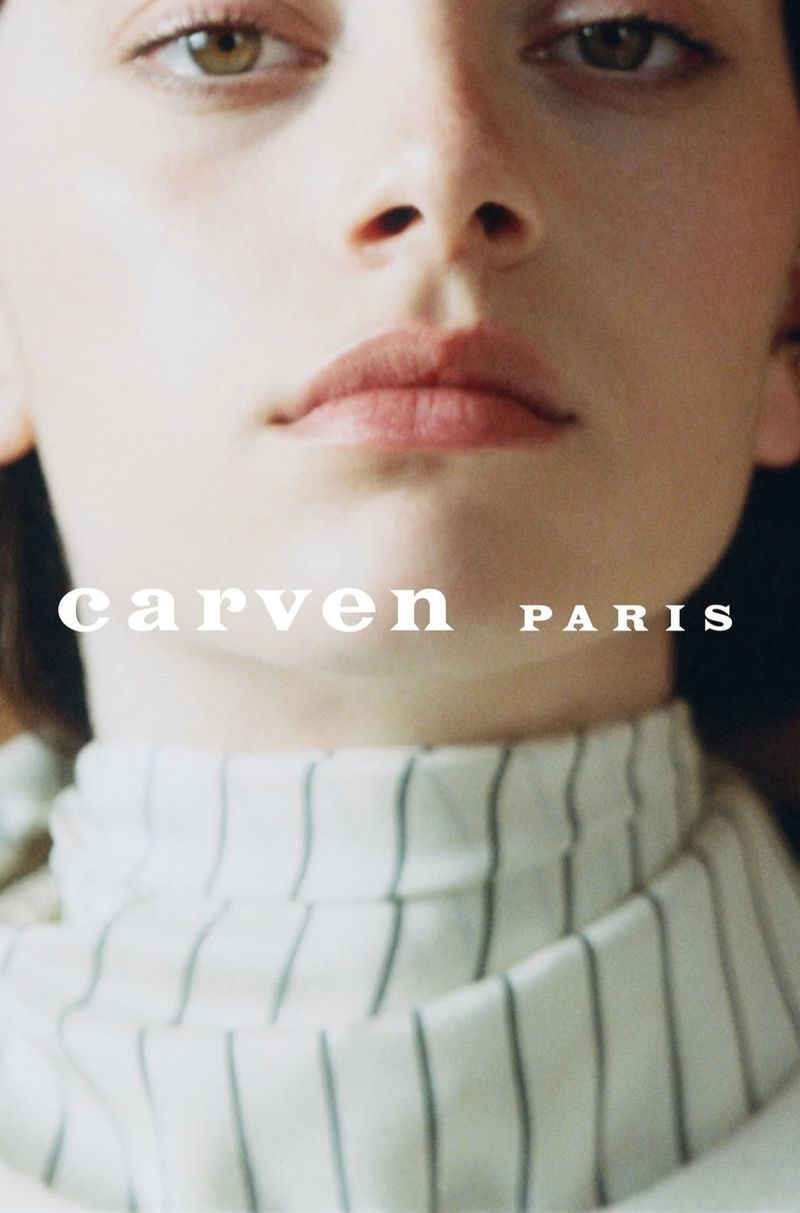 Close-up portrait of model Flavie Sammartano wearing a striped high-neck garment with Carven Paris typography overlay.