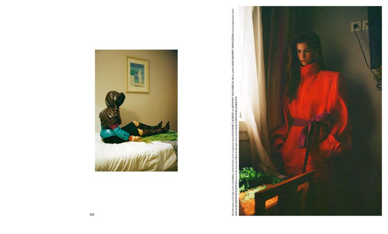Fashion editorial featuring an adult female model in a red coat near a window, and another model with a bed and wall art.