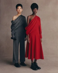 Two female models posing in Emilia Wickstead FW25 collection against a neutral backdrop