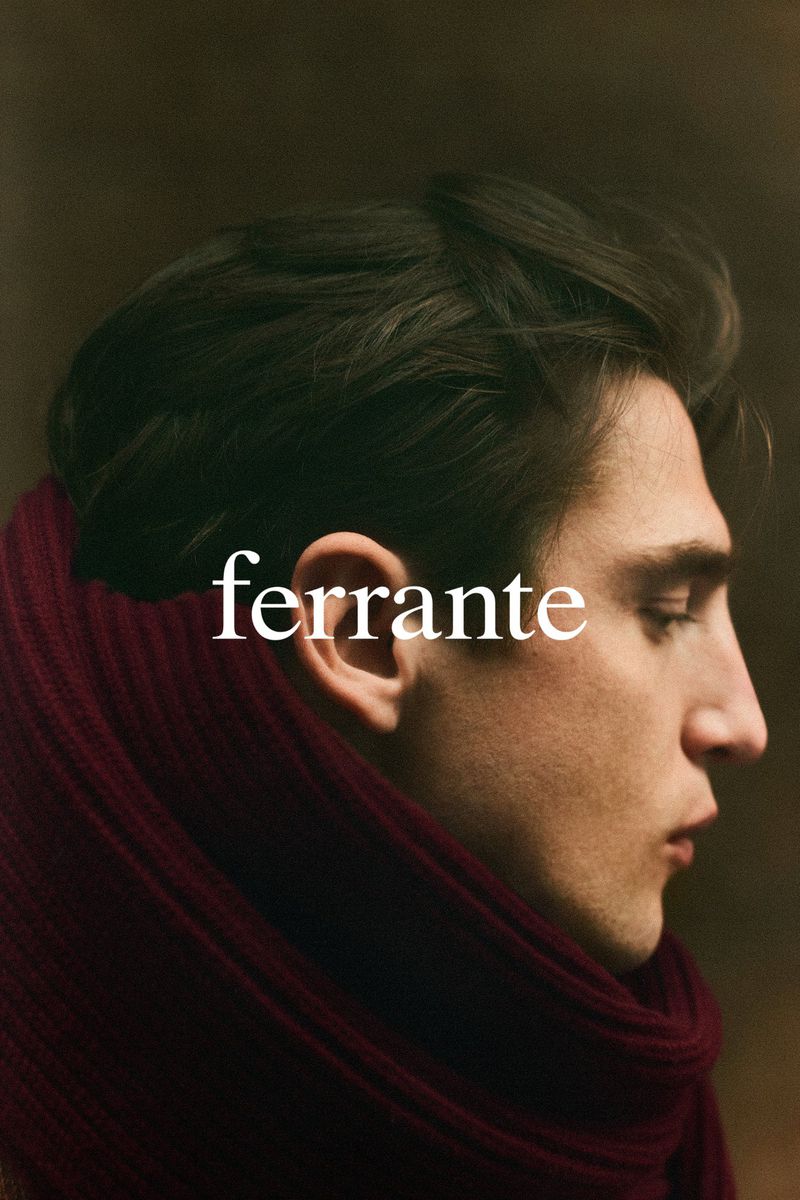 Profile portrait of an adult male with dark hair wearing a red scarf, showcasing a close-up and shallow depth of field.