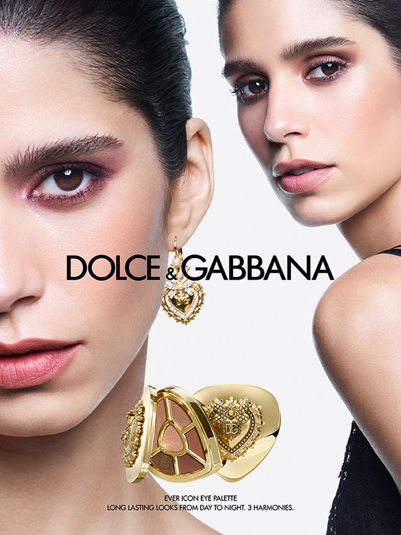Cosmetics advertising featuring two women with professional makeup wearing golden earrings, with Dolce & Gabbana brand logo and eye palette.