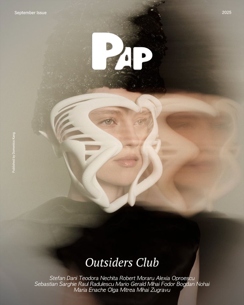 Magazine cover featuring a woman wearing a mask with superimposed ghostly face, in muted tones of grey and white with graphic PAP logo.