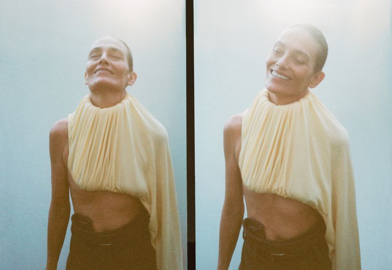 Woman smiling in a bright, vertical diptych image wearing a cream-colored top and dark pants against a pale blue background.