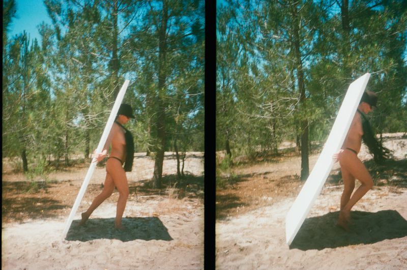 Topless adult carries white board in outdoor setting with trees and sand in a diptych style photograph, wearing black hat.