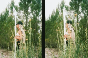 Model wearing a bowler hat and white top standing outdoors among tall pine trees and wildflowers for a Purple Magazine fashion editorial