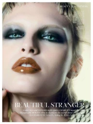 Close-up beauty portrait of model Karolina Spakowski with dark glossy smokey eyeshadow and high-shine caramel lip gloss.