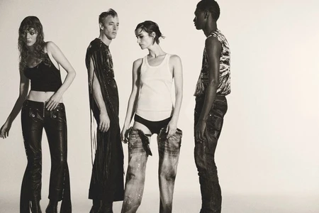 Four models posing in leather trousers, a white tank top, and distressed denim against a plain white studio background.