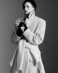 Monochrome fashion portrait of a model wearing a high collar coat and fingerless gloves for In Bloom by U Repubblica
