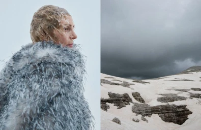 Model in textured white and grey coat with wet hair beside snowy mountain landscape under dark cloudy sky for Vogue Portugal