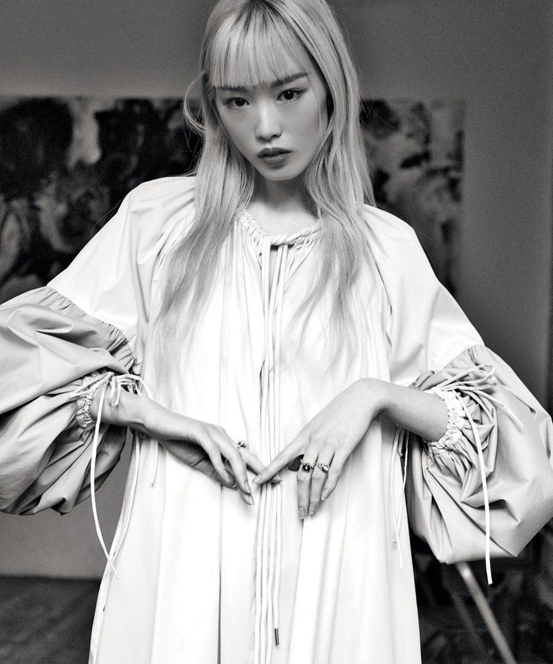 Monochrome portrait of Fernanda Ly wearing a voluminous light-colored dress with puffed sleeves for David Jones Express Yourself