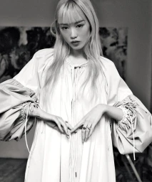 Monochrome portrait of Fernanda Ly wearing a voluminous light-colored dress with puffed sleeves for David Jones Express Yourself