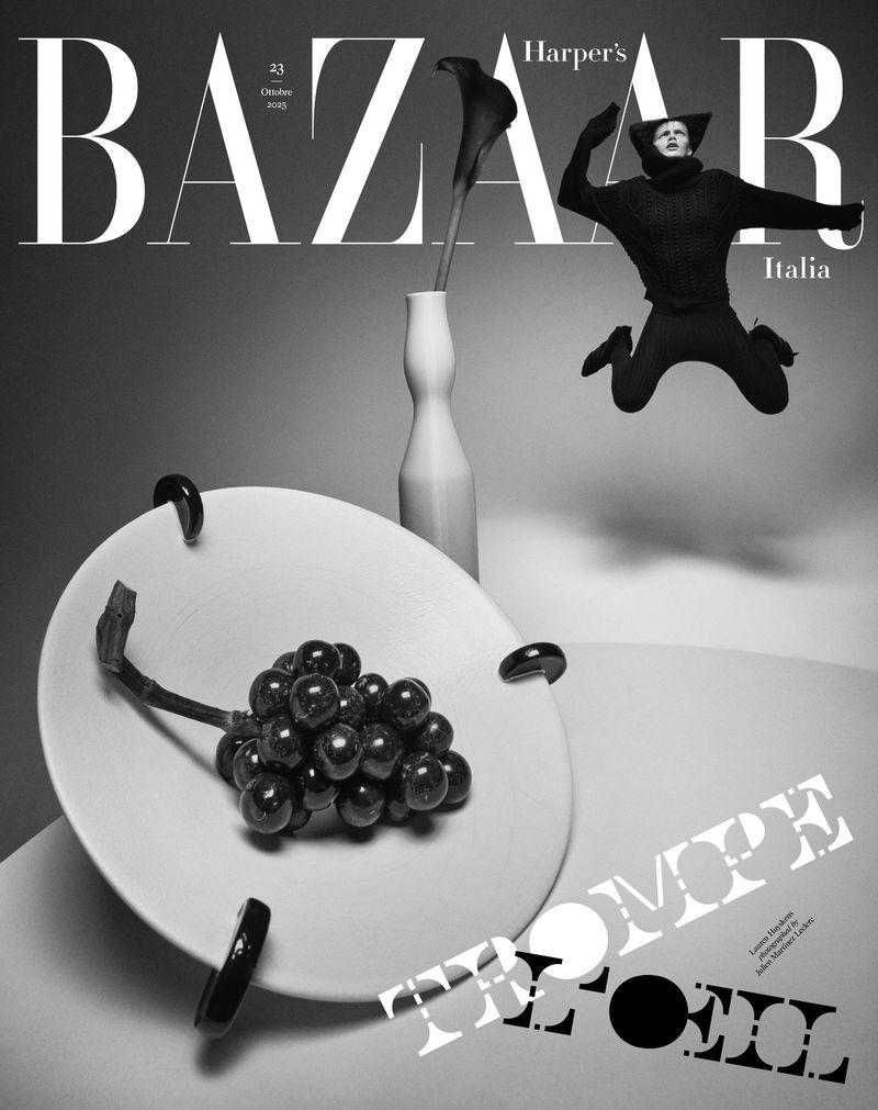Black and white fashion magazine cover featuring a person jumping, grapes on a plate, a vase with a flower, and Bazaar title text.