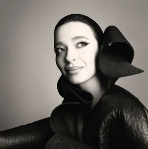 Portrait of Mikey Madison wearing a sculpted black garment for Vogue Italia photographed by Steven Meisel