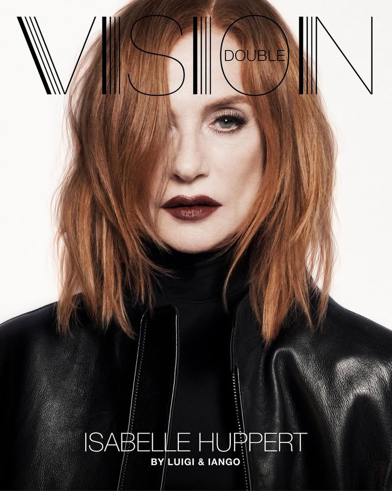 Close-up portrait of a woman with auburn hair, wearing a black leather jacket, on a white background, as seen on a magazine cover.