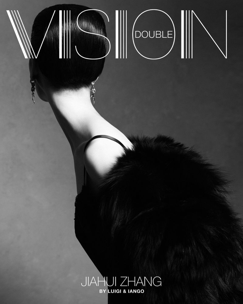 Black-and-white fashion shot featuring a woman with a sleek bob hairstyle, a fur stole, and elegant earrings against a grey backdrop.
