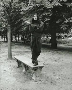 Renate Reinsve standing on a stone park bench wearing a dark turtleneck and trousers, photographed by David Luraschi for Mastermind Magazine.