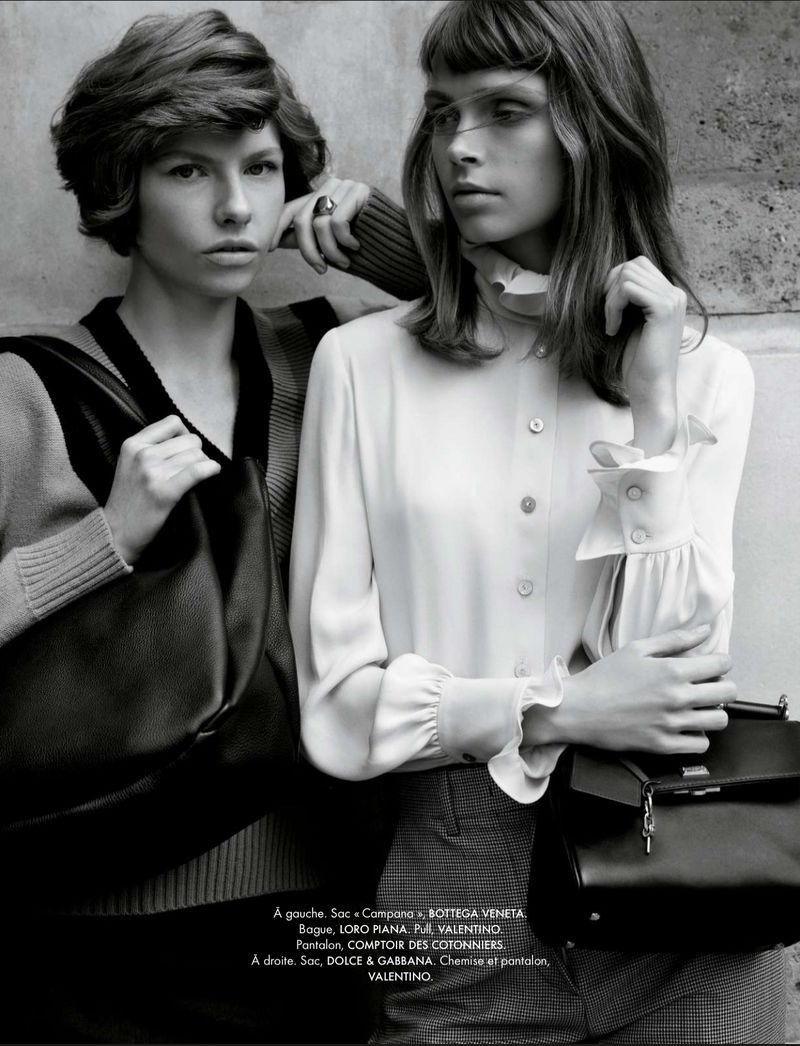 Two women in a fashion editorial pose with handbags. The image is black and white and features fashion, apparel, and accessories.
